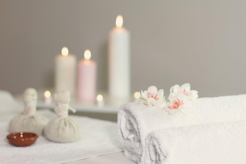 Warm Herbal Massage Table with Towels and Candles