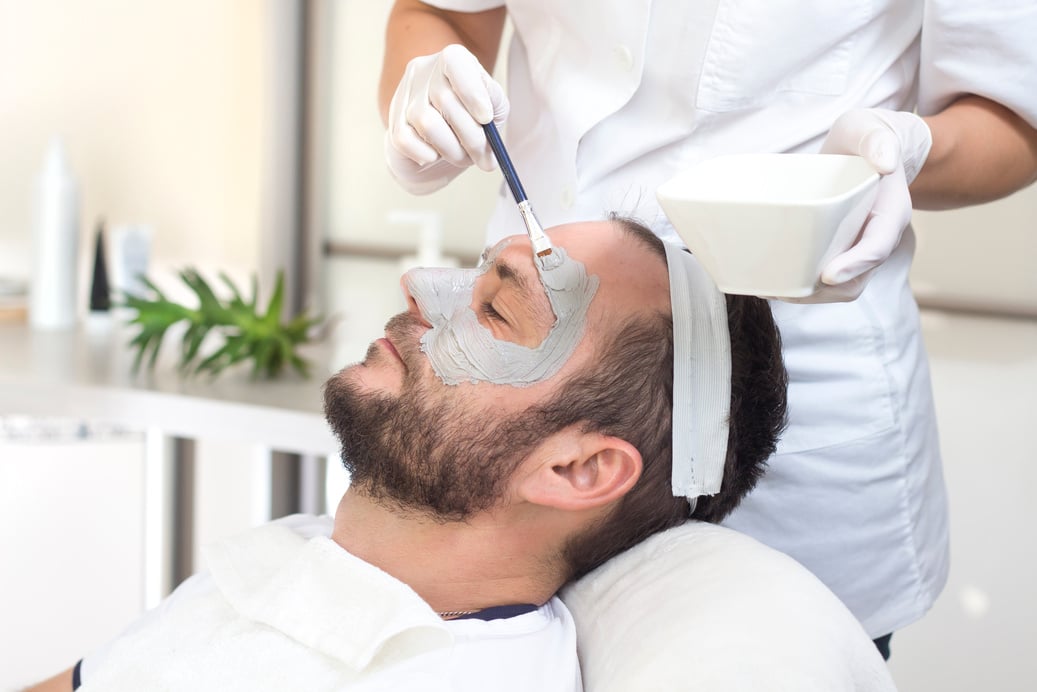 Men's care, a man in the beauty salon during the cosmetic treatment.